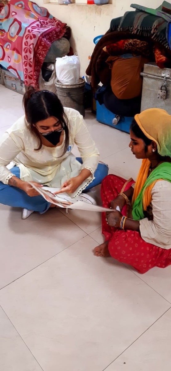 Pratisandhi facilitator reviewing learning material in a community setting